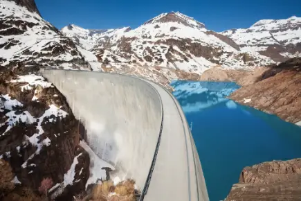 A large dam in a snow-covered mountain landscape.